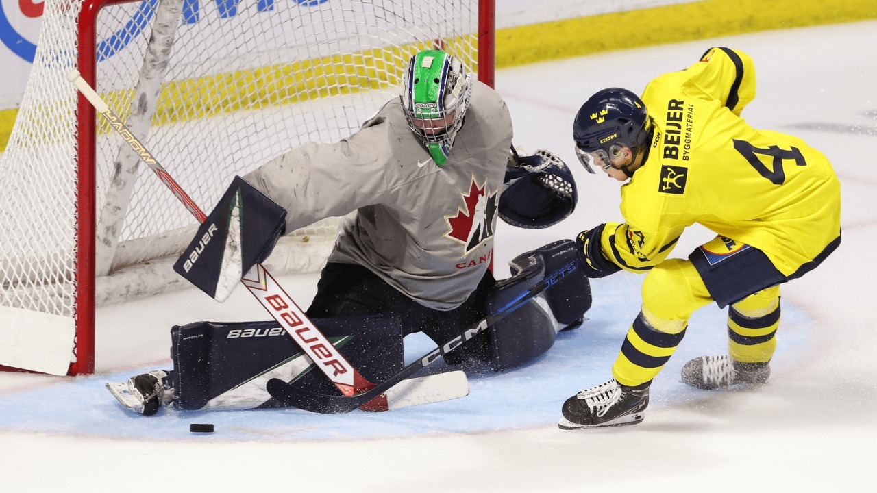 A player from the Sweden U20 ice hockey team tries to score past the goalie from Canada during the World Junior Ice Hockey Championship
