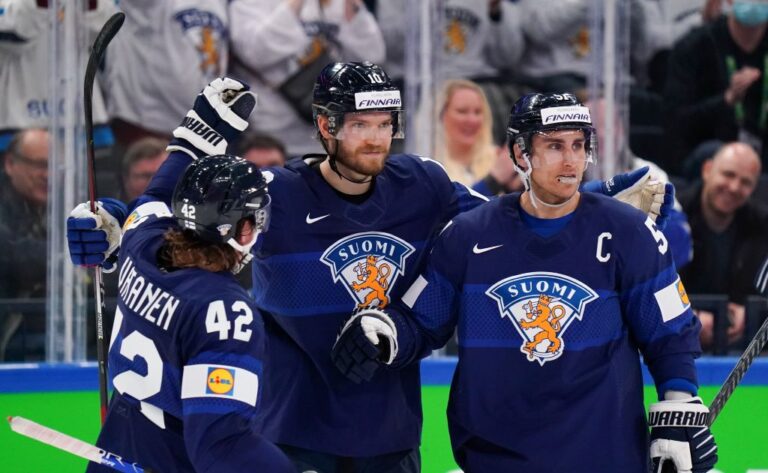 Players from Finland's Olympic ice hockey team celebrate after winning their group in the Winter Olympics 2022. Finland would go on to win the Gold medal. Ice hockey Olympics 2026 article featured image
