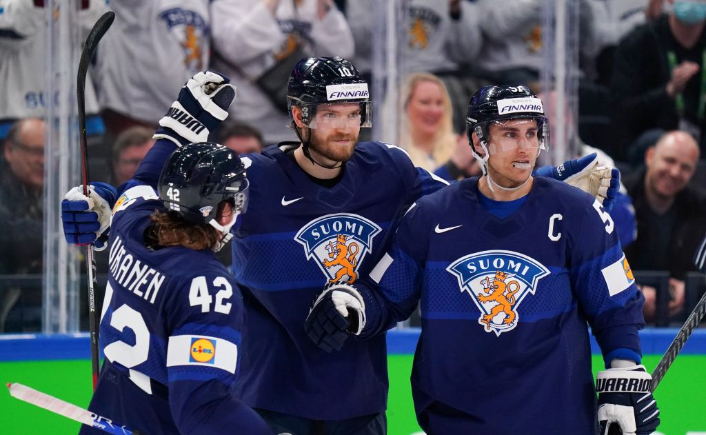 Players from Finland's Olympic ice hockey team celebrate after winning their group in the Winter Olympics 2022. Finland would go on to win the Gold medal. Ice hockey Olympics 2026 article featured image