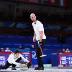 The Italian team during action in the mixed doubles event of the 2026 Olympic curling tournament featured image