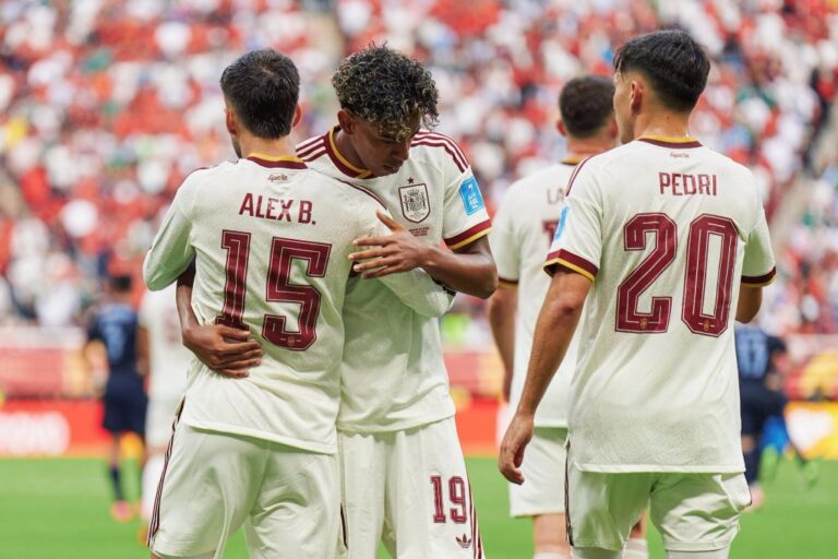 Spain players in white kits celebrate a goal, with Lamine Yamal hugging Alex Baena while Pedri stands nearby. Spain vs Austria Round of 32 World Cup 2026 featured image.